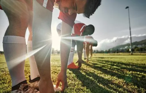 Soccer, sports and team stretching on field before match, training and practice. Soccer players doi.